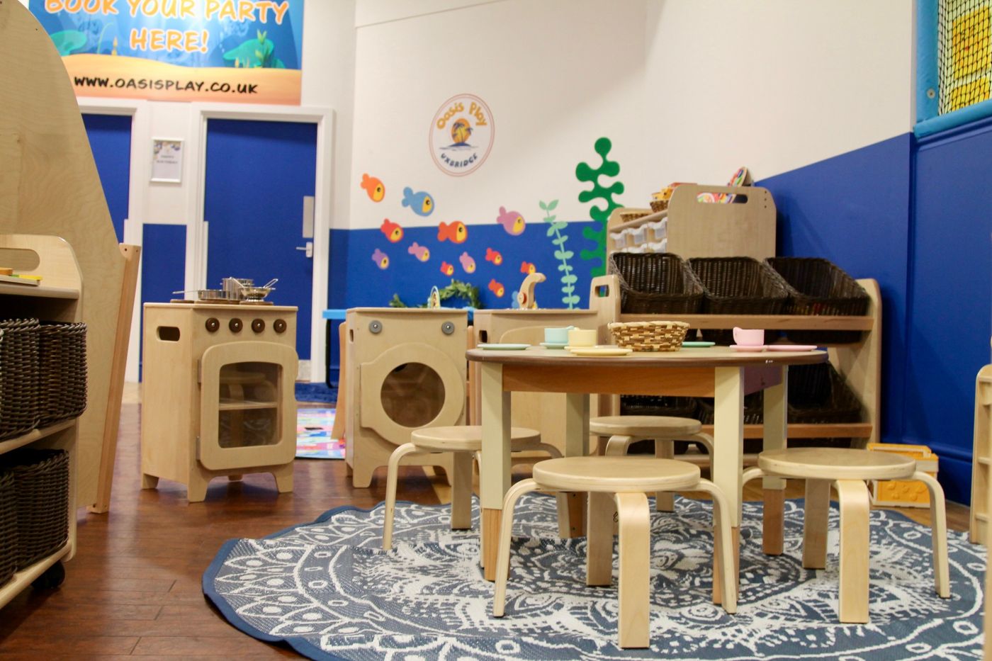 Play kitchen and round table on a patterned rug