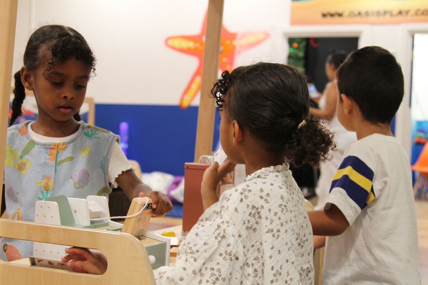 Children playing shop together at a wooden counter