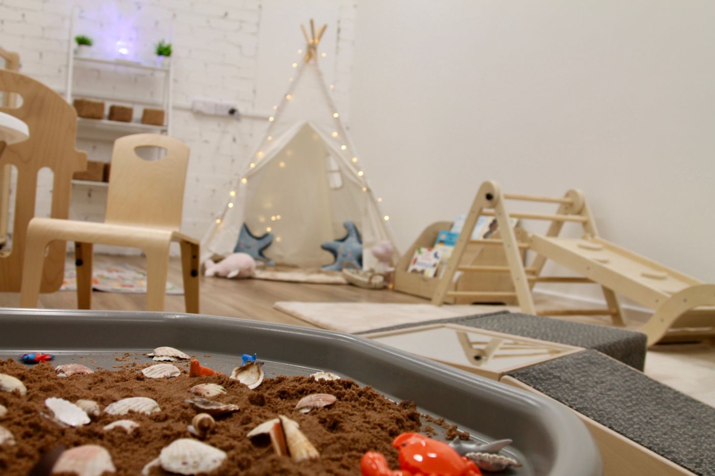 Sensory tuff tray with teepee in the background
