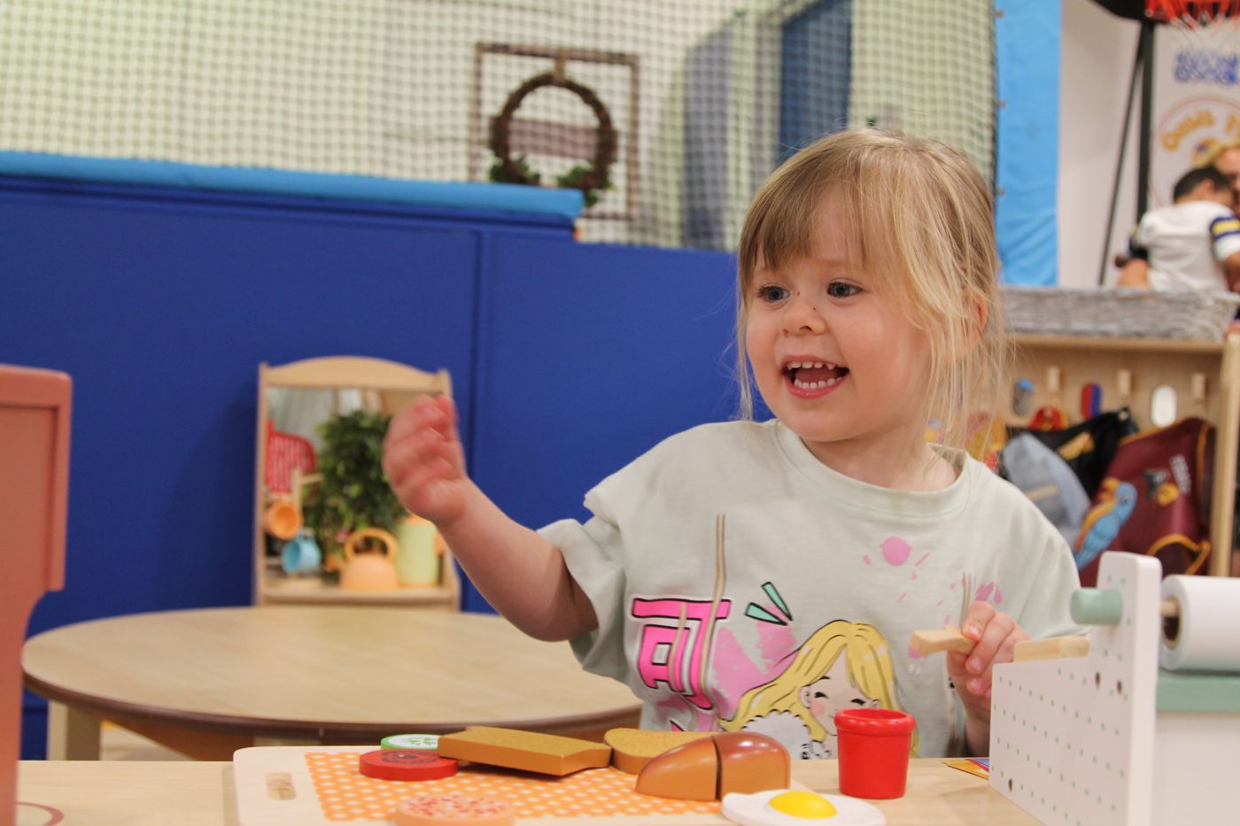 Child chopping wooden play food